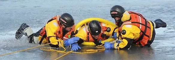 a person being saved from the sea by a rescue crew