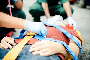 a person on a medical stretcher being examined by a doctor